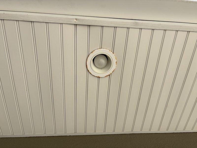 Replaced four exterior soffit light fixtures showing significant rust corrosion and deterioration around the trim rings due to moisture exposure and age. All fixtures were successfully removed and replaced with new units, restoring proper illumination and eliminating safety concerns associated with corroded electrical components in the exterior soffit area.