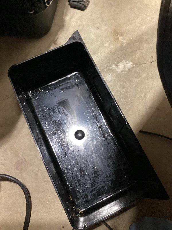 Completed annual cooling maintenance on 12-year-old Goodman system with 2022 condenser motor. Inspection revealed significant rust staining and corrosion on evaporator coil drip pan indicating prolonged moisture exposure, with condensate actively draining into auxiliary pan on floor. Documented interior component condition and verified condensate drainage system operation.