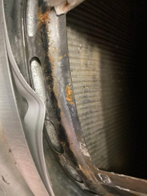 Responded to service call for non-operational water heater at property currently undergoing floor restoration work. Upon inspection, discovered significant rust and corrosion on heat exchanger assembly and surrounding metal housing, indicating prolonged moisture exposure and potential structural compromise. Examined burner assembly components, including burner cap with visible wear, discoloration, and residue buildup from previous operation. Documented extensive corrosion along metal seams and joints where housing meets coil assembly, with orange-brown oxidation indicating advanced deterioration. Photographed all affected components for warranty documentation and customer records. Unit remains non-operational due to corroded components requiring replacement. Coordinated timing with restoration company on-site for concurrent floor repairs.