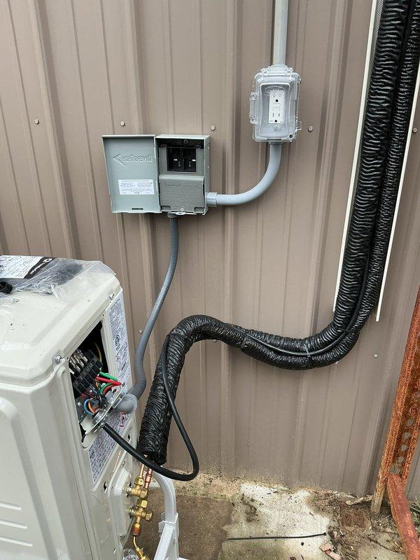 Completed full replacement and installation of unit heater system. Installed new wall-mounted ductless mini-split heating unit on interior wall with associated control switch and thermostat. Ran electrical service including exterior disconnect switch, junction boxes, and conduit routing along exterior corrugated metal siding. Connected gas line with brass fittings and installed service valve panel with proper labeling and weatherproof enclosures for all exterior electrical components.