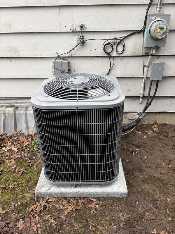 Completed full HVAC system replacement including installation of new Carrier furnace in basement utility area and outdoor condenser unit. Furnace installed on concrete pad with vertical supply ductwork connected and integrated with existing distribution system. Outdoor condensing unit positioned on concrete pad against building exterior with proper electrical connections, disconnect box, and conduit routing to service panel. All ductwork connections secured, electrical wiring completed per code requirements, and system tested for proper operation. Payment collected per authorization.