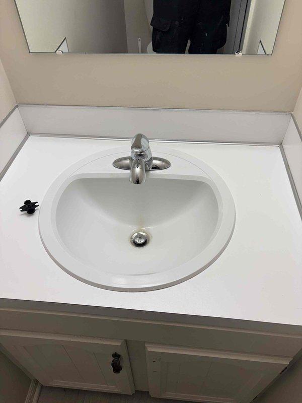 Responded to service call for multiple bathroom plumbing issues. Addressed intermittently running toilet, replaced broken flush handle on second toilet, and replaced leaking bathroom sink faucet. Water supply had been shut off to one toilet by homeowner prior to arrival. Inspected P-trap assembly and drain connections under sink during faucet replacement to ensure proper installation and verify no additional leaks in drainage system. All fixtures tested and confirmed operational upon completion.