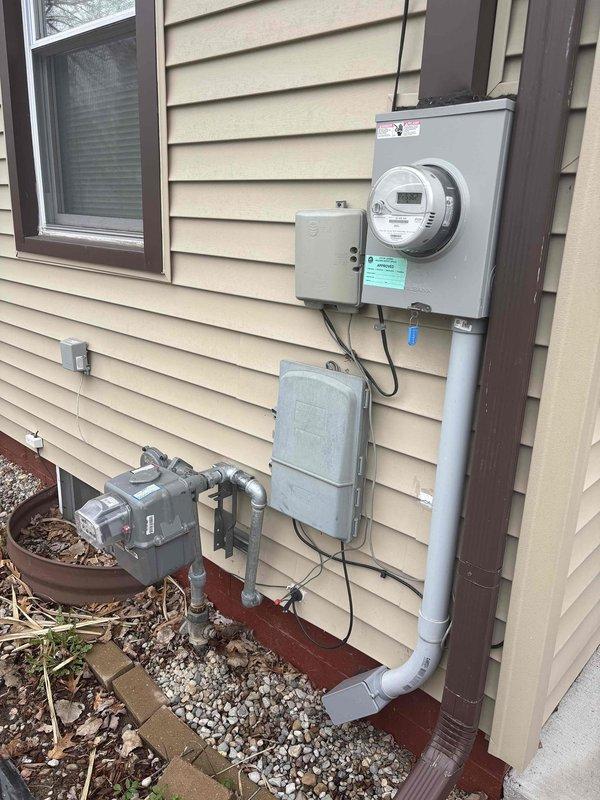 Completed natural gas connection and electrical hookup for standby generator installation at residential property. Installed gas line from existing meter to generator location, mounted electrical transfer switch and associated conduit on exterior wall near main electrical panel, and established proper grounding connections. All work performed to local code requirements with utility-grade materials and proper clearances maintained from structure.