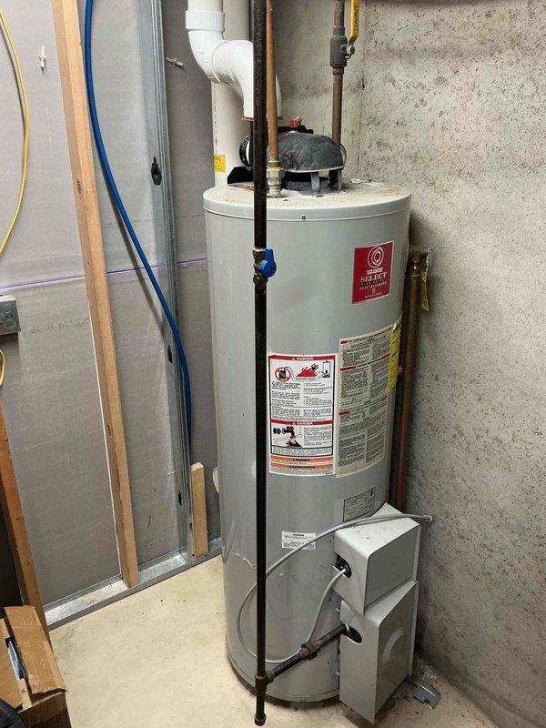 Responded to service call for water heater not heating properly and pilot light failing to remain lit. Upon arrival, inspected 20+ year old residential gas water heater installed in basement utility area. Unit exhibited classic symptoms of thermocouple failure and potential gas valve issues common in aging equipment. Evaluated all connections, venting system, and safety components. Discussed replacement options with customer given the age and condition of the existing unit. Customer enrolled in maintenance program for ongoing service protection. Documented equipment condition with photographs for reference.