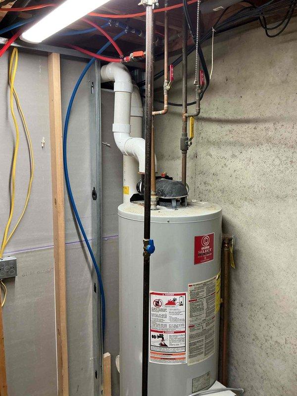 Responded to service call for water heater not heating properly and pilot light failing to remain lit. Upon arrival, inspected 20+ year old residential gas water heater installed in basement utility area. Unit exhibited classic symptoms of thermocouple failure and potential gas valve issues common in aging equipment. Evaluated all connections, venting system, and safety components. Discussed replacement options with customer given the age and condition of the existing unit. Customer enrolled in maintenance program for ongoing service protection. Documented equipment condition with photographs for reference.