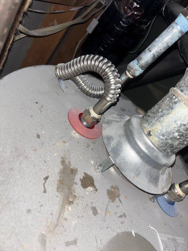 Completed inspector-required corrections on water heater installation. Installed combustion air supply to meet code requirements. Secured water heater vent connections with three screws at each joint per specifications. Added approved support strapping for vertical vent pipe to ensure proper stability and code compliance. System ready for re-inspection.