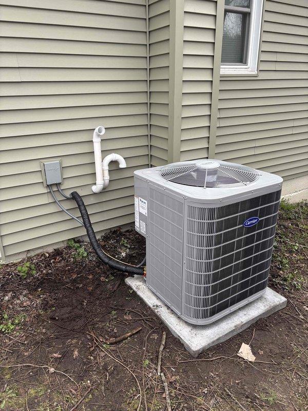 Completed full HVAC system installation including furnace, air conditioning unit, and water heater. Installed Carrier brand outdoor condensing unit on concrete pad with proper electrical disconnect and condensate drain line routing. Set up basement utilities including new water heater and furnace with appropriate PVC venting, ductwork connections, and piping infrastructure per approved specifications.