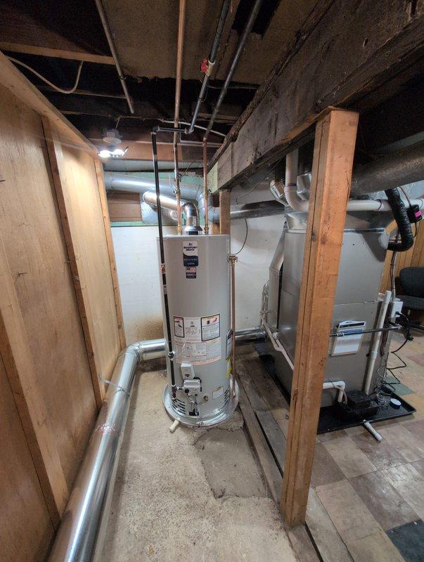 Completed full HVAC system installation including furnace, air conditioning unit, and water heater. Installed Carrier brand outdoor condensing unit on concrete pad with proper electrical disconnect and condensate drain line routing. Set up basement utilities including new water heater and furnace with appropriate PVC venting, ductwork connections, and piping infrastructure per approved specifications.