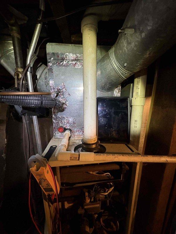 Responded to no heat call where blower was running continuously but producing only cool air. Upon inspection, discovered severe corrosion and moisture damage to the furnace control board, with extensive crystalline deposits and deterioration across the circuit board surface indicating prolonged exposure to environmental factors. Diagnosed failed control board as cause of blower malfunction and lack of heat production. Due to age of system (35+ years), recommended system replacement as most cost-effective solution rather than board replacement on aging equipment.