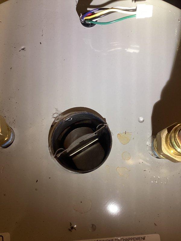 Completed warranty water heater repair by replacing failed inducer assembly. Removed old inducer motor from top of unit, installed new replacement part obtained from Ferguson Supply (part #743291549-001), and verified proper operation of draft inducer motor and pressure switch functionality upon completion.