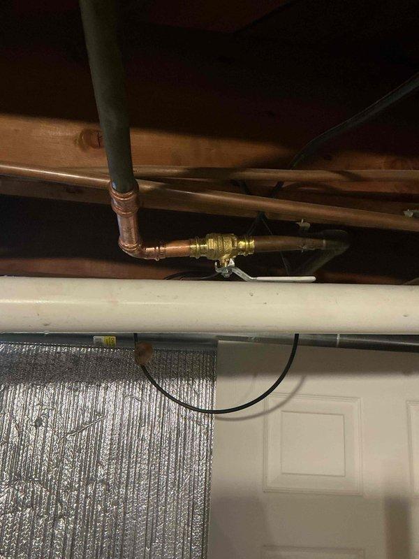 Responded to plumbing leak at outdoor spigot valve. Upon inspection, identified failed brass valve connection on copper supply line in ceiling/wall cavity area. Replaced defective valve assembly with new brass fitting, ensuring proper threaded connections and secure joints. Verified system integrity and confirmed leak was fully resolved with no additional water discharge.