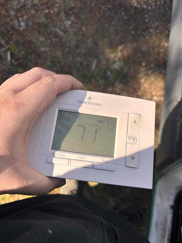 Completed annual cooling maintenance on 7-year-old EnergiAir unit with warranty coverage through October 2028. Verified thermostat operation and documented system settings showing unit in heating mode with room temperature at 62°F and setpoint at 73°F, confirming proper display and control functionality for seasonal transition.