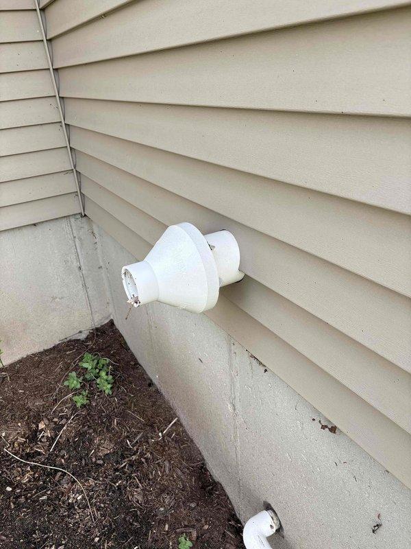 Responded to no heat call for 2008 Goodman furnace. Upon inspection, found condensate drain system experiencing drainage issues as evidenced by exterior wall staining below exhaust vent termination. Documented PVC vent pipe configuration and condensate discharge points. System evaluated for proper venting and drainage functionality to restore heating operation.