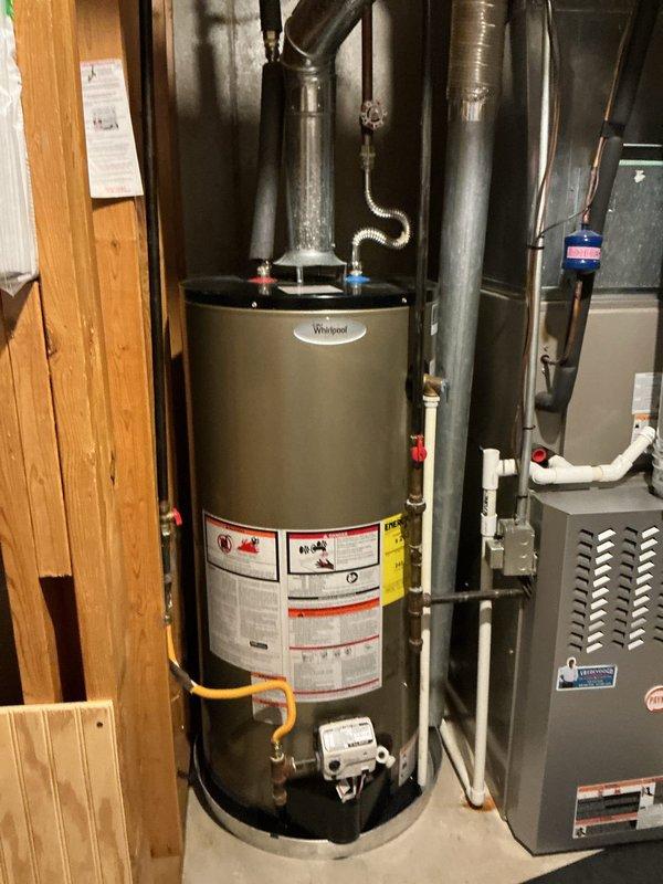 Responded to water leak emergency at residential property. Upon arrival, inspected Whirlpool water heater in basement utility area and surrounding plumbing connections. Assessed leak source, documented existing conditions with photographs, and provided homeowner with containment recommendations and next steps for repair or replacement of affected unit.