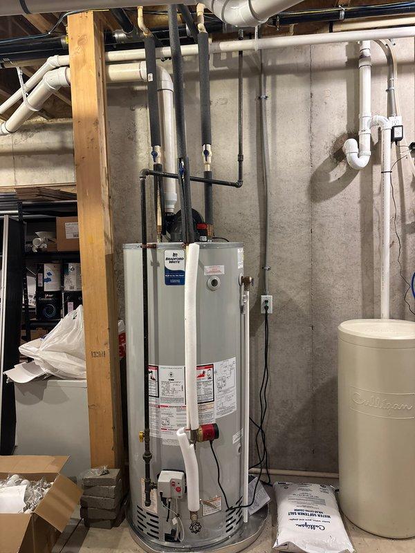 Provided comprehensive estimate for replacement of hot water recirculation pump system in basement utility area. Assessed existing plumbing infrastructure including water heater connections, supply lines, and circulation piping configuration. Documented current system setup with PVC and copper piping, identified pump location and connection points, and evaluated compatibility requirements for new recirculation pump installation.