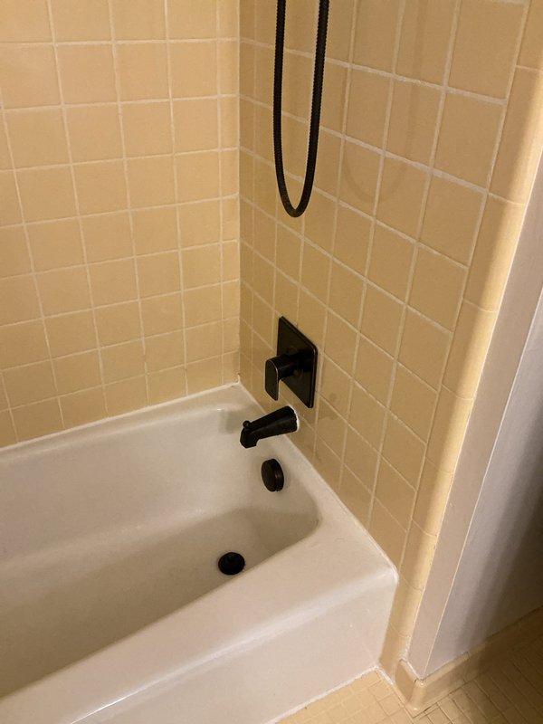 Responded to complaint of rotten egg odor throughout home and lack of hot water at shower faucet. Inspected bathroom plumbing system and identified issue with water heater anode rod causing sulfur bacteria buildup, which produces hydrogen sulfide gas responsible for the characteristic rotten egg smell. Evaluated shower mixing valve and confirmed hot water supply line obstruction preventing adequate hot water flow to the fixture. Flushed water heater tank to remove sediment and bacterial contamination, replaced deteriorated magnesium anode rod with aluminum/zinc alloy anode to prevent future sulfur odor issues. Cleared blockage in hot water supply line and tested shower valve operation to verify proper temperature mixing and flow restoration. All plumbing fixtures now functioning properly with no residual odors detected.