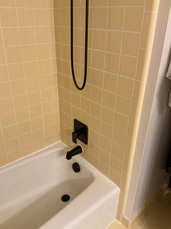 Responded to complaint of rotten egg odor throughout home and lack of hot water at shower faucet. Inspected bathroom plumbing system and identified issue with water heater anode rod causing sulfur bacteria buildup, which produces hydrogen sulfide gas responsible for the characteristic rotten egg smell. Evaluated shower mixing valve and confirmed hot water supply line obstruction preventing adequate hot water flow to the fixture. Flushed water heater tank to remove sediment and bacterial contamination, replaced deteriorated magnesium anode rod with aluminum/zinc alloy anode to prevent future sulfur odor issues. Cleared blockage in hot water supply line and tested shower valve operation to verify proper temperature mixing and flow restoration. All plumbing fixtures now functioning properly with no residual odors detected.