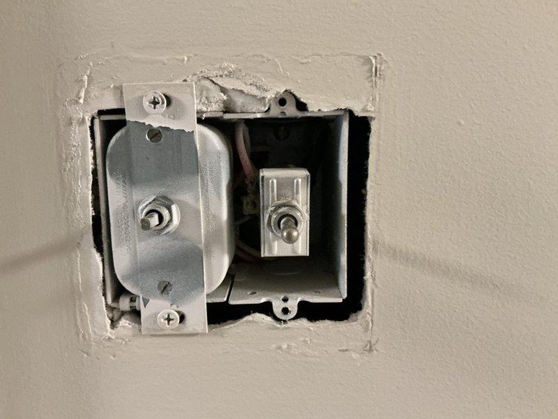 Performed thorough inspection of attic fan system including electrical switch box installation and attic-mounted fan unit. Examined switch mounting hardware, wiring connections, and operational functionality. Assessed attic fan installation, surrounding insulation condition, and verified proper ventilation system operation.