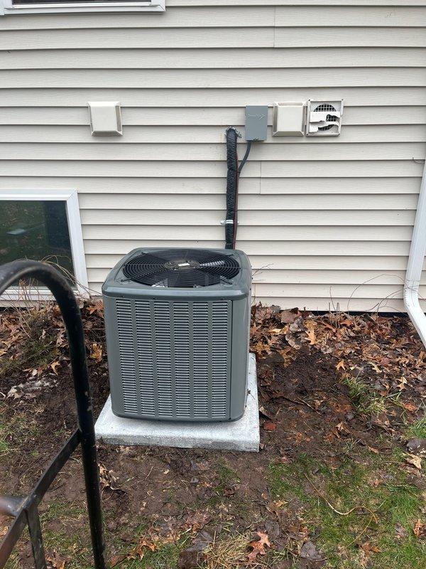 Successfully completed full HVAC system and water heater installation at residential property. Installed new outdoor air conditioning condenser unit on concrete pad with proper refrigerant line routing and electrical disconnect box mounted to exterior siding. Indoor air handler unit installed in basement utility room with PVC condensate drain line assembly and electrical service connection. New water heater installed to replace existing unit. All refrigerant lines properly insulated and secured with mounting brackets along exterior wall. Condensate drainage system configured with multiple PVC elbows for proper pitch and drainage. Electrical connections completed per code requirements including dedicated disconnect switches. All equipment tested for proper operation, airflow verified, and system commissioned. Installation meets manufacturer specifications and local building codes.