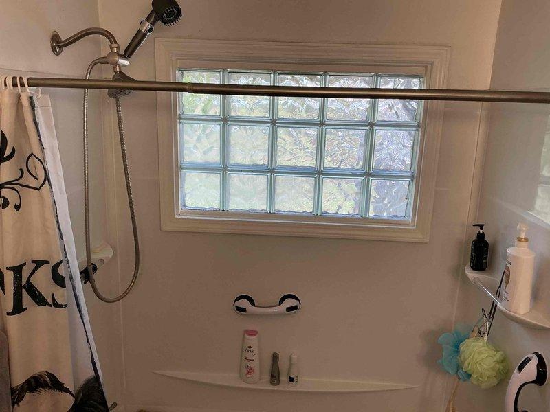 Conducted on-site assessment and documentation for tub/shower to walk-in shower conversion in 1955-era home. Evaluated existing bathtub and shower combination unit with glass enclosure, grab bars, glass block window, and current plumbing configuration to determine scope of work required for accessible walk-in shower installation. Photographed bathroom layout, existing fixtures, wall conditions, and spatial constraints to develop comprehensive project estimate for barrier-free shower conversion.