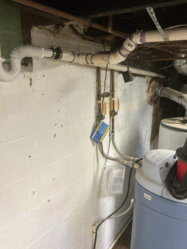 Responded to water leak emergency in basement affecting multiple mechanical systems. Upon arrival, found rainwater intrusion causing standing water that had compromised furnace operation by triggering safety float switch in drain pan. Malfunctioning sump pump was unable to remove water, allowing accumulation around HVAC equipment and Rheem 40-gallon natural gas water heater (Model 42V40SF, manufactured 12/2007). Assessed water damage to furnace, hot water heater, and surrounding plumbing infrastructure including copper gas lines and PVC drainage system. Documented conditions of all affected equipment and water infiltration points for further remediation planning.