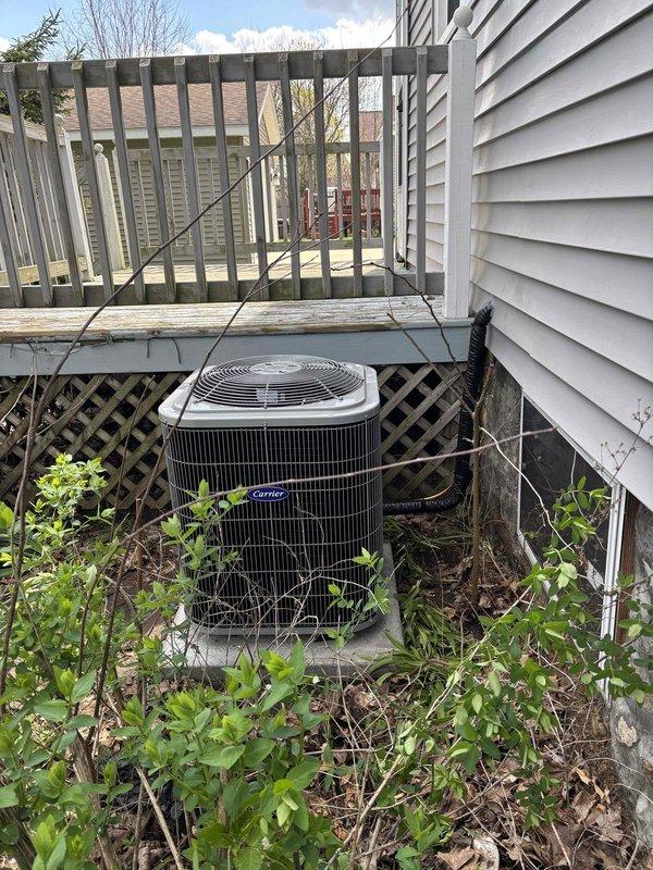 Successfully completed full HVAC system installation including new Carrier condensing unit positioned on concrete pad with protective wire cage enclosure and new furnace unit installed in basement utility area. All ductwork connections, including flexible silver ducting, were properly secured and integrated with existing infrastructure. System tested and verified operational with all components functioning per manufacturer specifications.