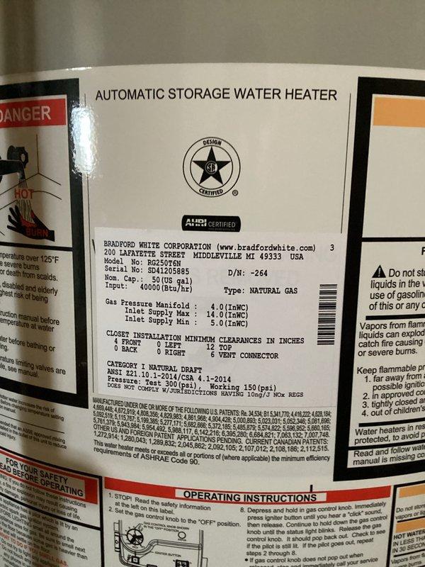 Responded to service call for leaking water heater. Upon arrival, inspected Bradford White Defender Safety System model RG250T6N, a 50-gallon natural gas water heater with 40,000 BTU input rating. Conducted thorough visual examination of unit and surrounding plumbing connections to identify source of leak. Documented water heater condition, manufacturer specifications, and installation setup with photographs for service records. Unit appears to be approximately 10 years old based on service history provided. Assessed all visible plumbing connections, valves, and fittings at top of tank, as well as temperature and pressure relief valve and drain valve at base of unit to determine leak origin and recommend appropriate repair or replacement options.