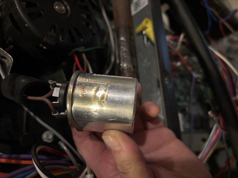 Completed annual heating maintenance on 11-year-old Goodman furnace system without humidifier. Performed comprehensive tune-up including inspection of blower motor assembly, electrical connections, and control components. Evaluated and tested capacitor functionality, inspecting terminals and connections for proper operation. Verified all wire harnesses and electrical connections were secure with appropriate cable management in place. Documented equipment condition with photos showing blower motor housing, mounting hardware, and electrical components in operational status.