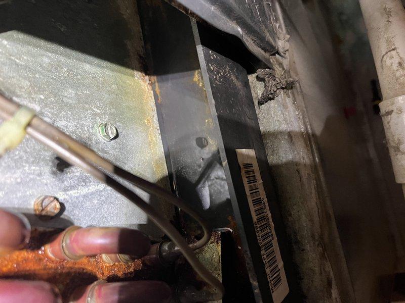 Completed annual cooling maintenance on 16-year-old Goodman system. Documented significant rust and corrosion on evaporator coil housing and air handler components, indicating prolonged moisture exposure and condensation issues. Refrigerant lines show discoloration but remain serviceable; however, extensive deterioration of metal framework and horizontal surfaces poses concern for system longevity and potential failure points.