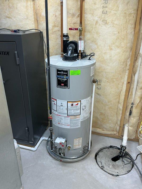 Responded to service call for leaking Bradford White RG1PV50S6N water heater installed in 2018. Upon inspection, confirmed internal tank failure with leaking from the unit itself, not from the pressure relief valve or drain valve. Assessed the 50-gallon residential electric water heater located in unfinished basement utility area with exposed stud walls and concrete flooring. Documented existing installation including copper supply line connections, electrical connections, and current plumbing configuration. Provided estimate for complete water heater replacement due to compromised inner tank integrity.