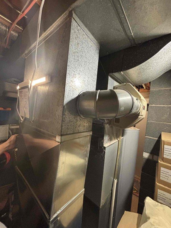 # HUM-Humidifier Problem

Responded to service call for humidifier running constantly on Lennox unit approximately fifteen years old. Upon inspection, found aging humidifier control system failing to properly cycle with heating system operation. Evaluated humidifier saddle valve, water supply line with braided stainless steel flex connector, and humidifier pad condition. Verified HVAC air handler and ductwork connections were secure and functioning properly. Documented existing equipment configuration with photos showing galvanized air handler unit, insulated ductwork, and humidifier assembly mounted to supply plenum. Assessed humidifier solenoid valve operation and water flow control mechanism. Due to age of unit and continuous operation issue, recommended humidifier replacement to restore proper humidity control and prevent potential water damage or system inefficiency. System heating function confirmed operational throughout inspection.