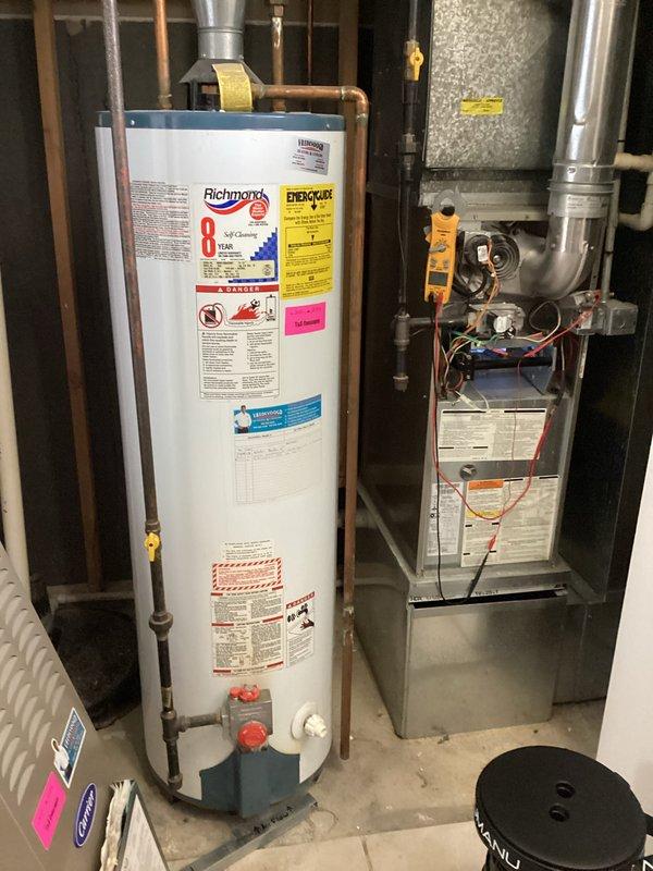 Completed comprehensive rental property inspection including AC tune-up service on residential HVAC system. Inspected and serviced 16-year-old Carrier furnace, 27-year-old Richmond water heater, and air conditioning unit in basement mechanical room. Documented equipment condition with photographs showing proper installation of copper and PVC plumbing connections, ductwork routing, and overall system accessibility for future maintenance.