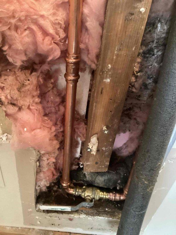 Responded to a plumbing emergency involving two busted 2/3" supply lines feeding outdoor faucets, with one line located in the ceiling cavity. Upon inspection, identified failed copper piping within the wall framing that required immediate replacement. Removed damaged sections of copper supply line, installed new copper pipe with proper fittings and brass valves, and tested all connections for leaks. Restored water supply to both exterior hose bibs and verified proper operation of shutoff valves.