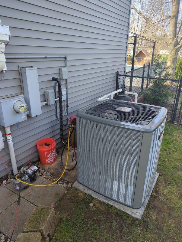 Completed full HVAC system replacement including new furnace and air conditioning condensing unit. Installed outdoor AC unit on concrete pad with proper refrigerant line connections, electrical service, and condensate drainage system using PVC piping. All components properly mounted to exterior wall with code-compliant electrical connections to meter base, system tested and operational.