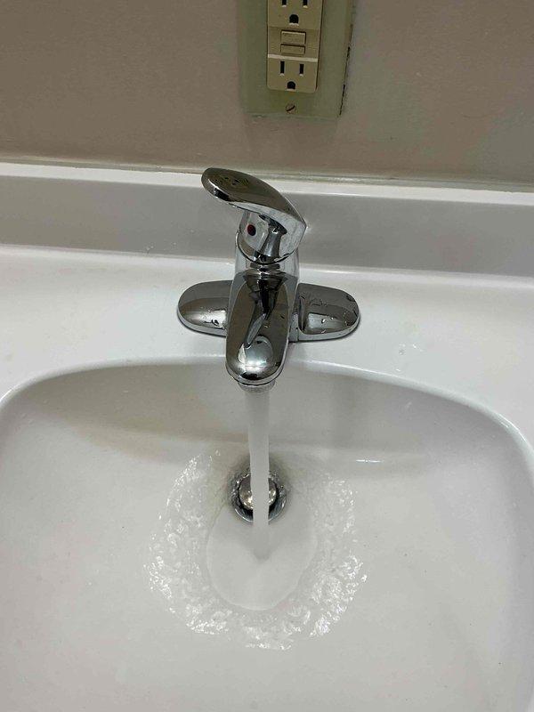 Responded to service call for previously installed bathroom faucet experiencing irregular spray pattern from spout. Upon inspection, diagnosed aerator blockage causing water dispersion issues. Disassembled faucet aerator, removed mineral deposits and debris causing obstruction, cleaned all components, and reassembled fixture. Tested water flow at multiple pressure levels to verify proper stream pattern and confirm resolution. Faucet now operating correctly with smooth, consistent water flow from spout.