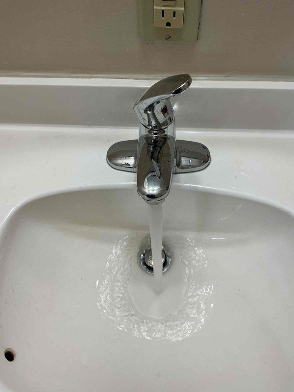 Responded to service call for previously installed bathroom faucet experiencing irregular spray pattern from spout. Upon inspection, diagnosed aerator blockage causing water dispersion issues. Disassembled faucet aerator, removed mineral deposits and debris causing obstruction, cleaned all components, and reassembled fixture. Tested water flow at multiple pressure levels to verify proper stream pattern and confirm resolution. Faucet now operating correctly with smooth, consistent water flow from spout.