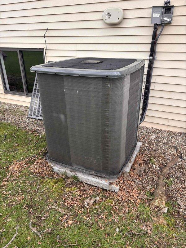 Completed annual cooling maintenance on 2021 EnergiAir system. Performed comprehensive tune-up including inspection of outdoor condensing unit, verified electrical connections at disconnect box, checked refrigerant lines and conduit connections, and cleared debris from base of unit. Noted significant paint deterioration and coating failure on outdoor unit cabinet requiring monitoring for potential rust development, but unit remains operational with all mechanical and electrical components functioning within normal parameters.