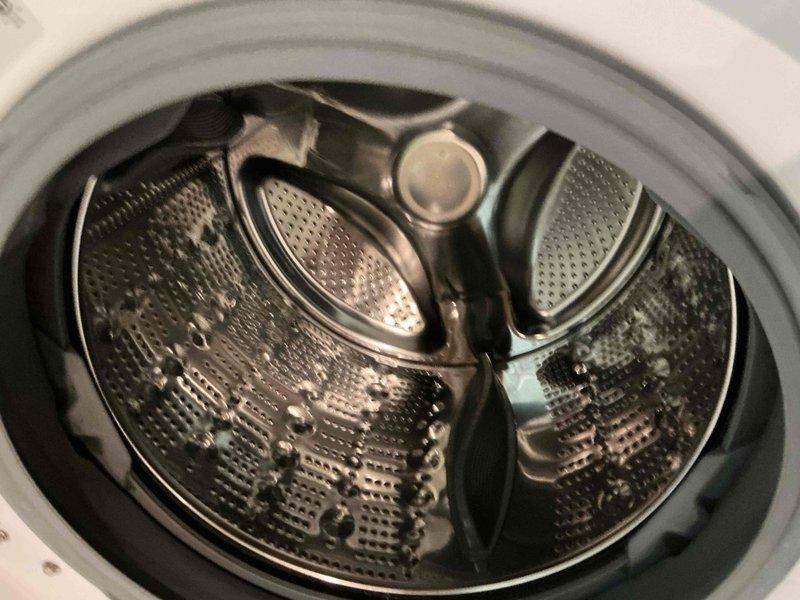 Responded to water leak call in front of washing machine, initially suspected to be from humidifier line. Upon inspection, examined LG front-loading washer and surrounding area, including drainage connections and hose routing along wall. Photographed washing machine interior drum and exterior installation to document condition and identify potential leak source.