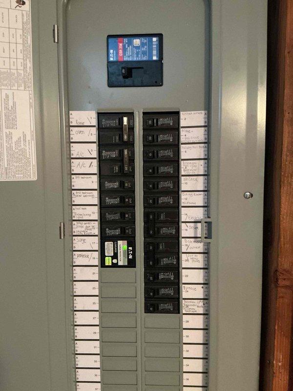Completed 200-amp electrical service upgrade at residential property. Coordinated utility company power disconnect and reconnect to safely replace exterior meter base, weatherhead assembly, and main service panel. Installed new gray metal meter socket and breaker panel enclosure on exterior wall with proper conduit runs and grounding. Upgraded interior breaker panel with modern circuit breakers, main disconnect, and circuit labeling for all branch circuits including HVAC and general lighting loads. All work performed under electrical permit and passed final inspection.