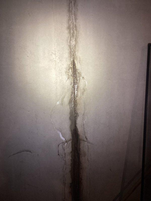 Returned to property to complete quoted repair work on water heater system. Successfully replaced defective gas valve and installed new temperature relief valve to restore safe operation of the unit. Coordinated entry access through neighbor as homeowners were traveling. Documentation photos captured existing water damage conditions in basement area, including significant moisture staining on concrete floor and vertical water staining on wall surfaces, indicating separate ongoing moisture intrusion issues requiring future attention. Water heater repairs completed successfully and system returned to proper working order.