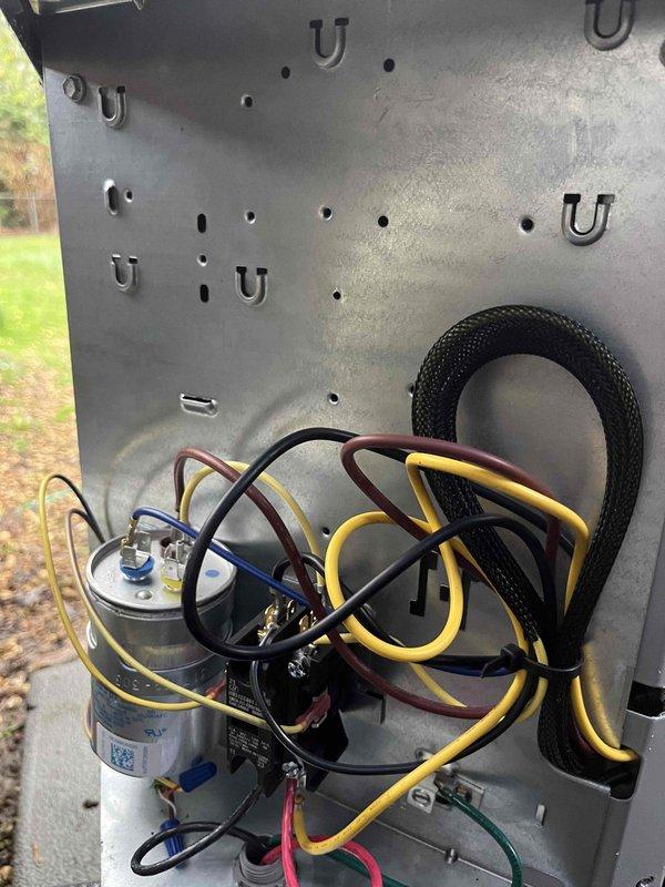 Completed annual cooling maintenance on 0-year-old Carrier unit model WT 03-2031. Performed comprehensive system inspection including electrical components, capacitors, and control board mounted in basement utility area. Verified all wiring connections secure, checked capacitor operation, and confirmed proper routing of electrical conduit and refrigerant lines. System tested and operating within normal parameters. Documentation photos captured for service records.