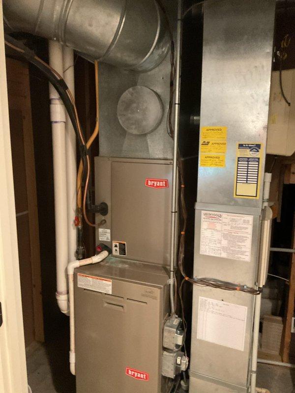 Performed comprehensive air conditioning tune-up on 22-year-old Bryant system. Inspected and tested all system components for proper operation. Cleaned and tested condensate drain lines, treating with TotalTabs time-released cleaning tablets. Cleaned outdoor condensing unit and coil to restore optimal heat transfer efficiency.

During inspection, verified refrigerant levels are significantly low, marking the third occurrence of low refrigerant on this system. Unit is not cooling to full capacity due to refrigerant deficiency. Conducted thorough leak search at both indoor and outdoor units but found no visible signs of UV dye from previous leak detection efforts. Completed leak fact sheet documentation. System requires 1-2 pounds of R22 refrigerant to restore proper charge.

Discovered active mouse nest in bottom of outdoor condensing unit requiring removal. Documented photos of both outdoor condensing unit positioned on concrete pad with electrical disconnect, and indoor Bryant furnace