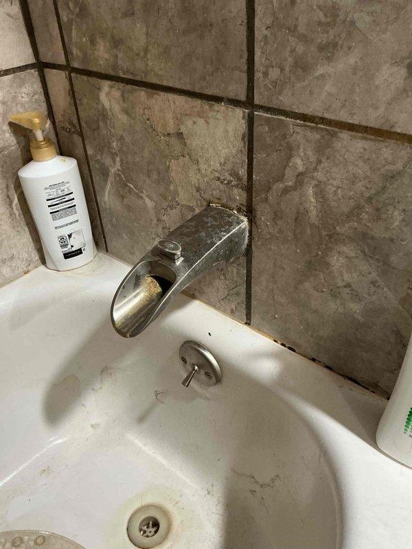 Responded to service call for reported leaking pipe beneath kitchen sink and basement piping in 30-year-old residential property with minor water damage. Conducted comprehensive plumbing inspection of affected areas including kitchen sink plumbing connections, basement pipe runs, and accessible crawl space/attic plumbing infrastructure. Documented existing conditions through photographic survey showing bathroom fixtures with modern waterfall-style faucet installation, gray PVC drainage piping with multiple joints and fittings in upper crawl space area, and wooden framed attic access point. Assessed integrity of visible plumbing connections, identified potential leak sources at pipe joints and fixture connections, and evaluated extent of water damage to surrounding areas. Provided detailed project estimate for necessary repairs to address active leaks and prevent further water intrusion.