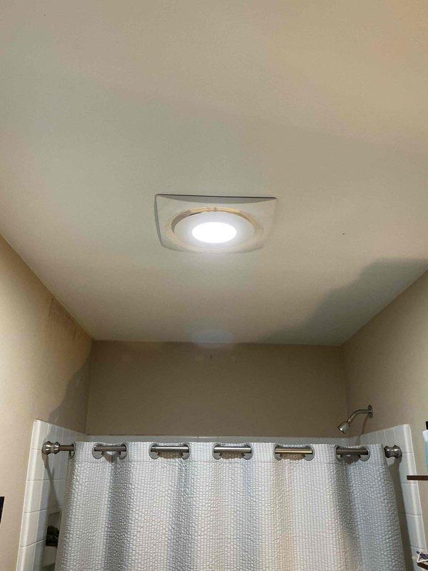 Completed bathroom exhaust fan replacement using client-supplied unit. Removed existing fan assembly, installed new ventilation fan in ceiling location above shower area, verified proper electrical connections at wall switch, and confirmed operational functionality with illuminated test.