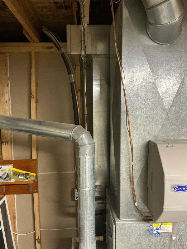 Conducted comprehensive estimate for furnace, air conditioning, and water heater replacement at residential property. Inspected existing Carrier HVAC system in unfinished basement mechanical room, documenting current ductwork configuration including horizontal main trunk line with 90-degree vertical transition, refrigerant line routing, and equipment cabinet condition. Evaluated electrical service panel capacity and circuit availability, noting dedicated circuits for existing furnace and A/C unit, to ensure adequate power supply for proposed equipment upgrades.