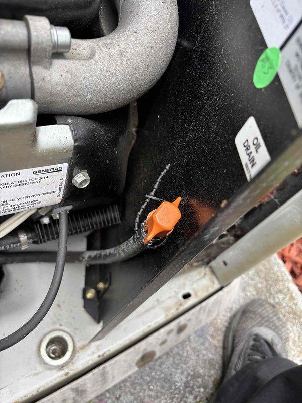 Performed comprehensive 5-year tune-up service on Generac standby generator unit. Completed full system inspection including fluid level verification via dipstick, examination of fuel line connections and hose assemblies, and assessment of all mounting hardware and structural components. Inspected gas valve assembly with brass fittings and rubber fuel lines, noting surface corrosion patterns consistent with outdoor installation and normal weathering. Verified proper operation of all mechanical connections, clamps, and securing hardware throughout the system. All components found to be functioning within manufacturer specifications upon completion of preventive maintenance service.