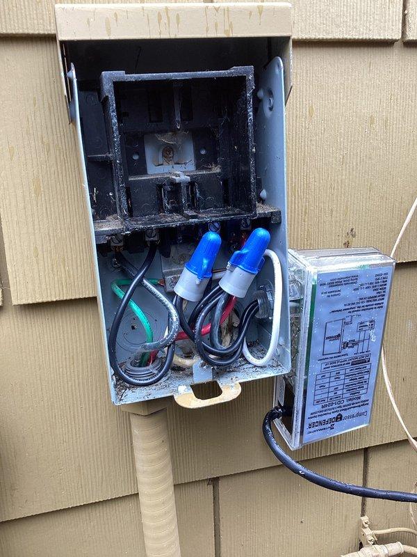 Responded to no cooling complaint on 2015 Carrier air conditioning system. Upon inspection, discovered severe electrical fire damage in the outdoor disconnect box with heavy charring, soot buildup, and heat damage to internal components, wiring connections, and mounting terminals. Documented extensive burn damage to electrical compartment which rendered the disconnect unsafe and inoperable. Unit unable to operate due to compromised electrical safety components requiring immediate disconnect replacement and electrical system evaluation before system can be restored to service.