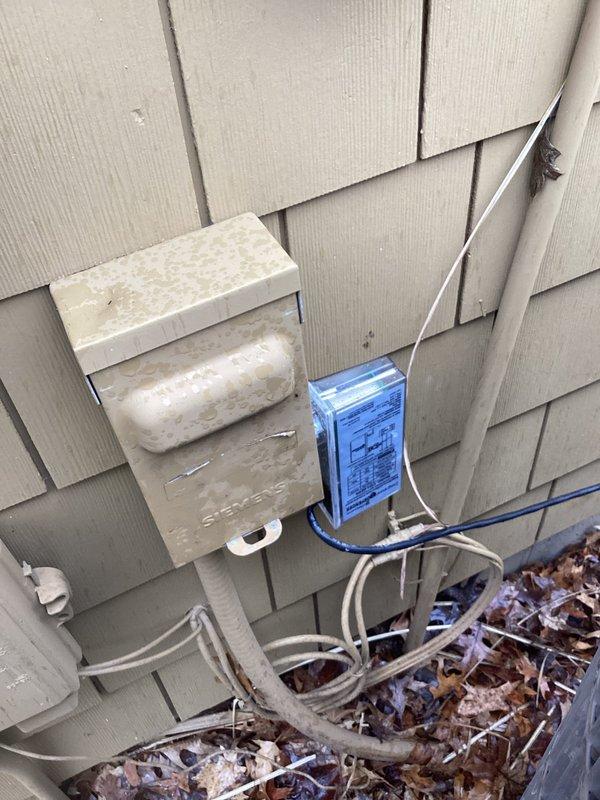 Responded to no cooling complaint on 2015 Carrier air conditioning system. Upon inspection, discovered severe electrical fire damage in the outdoor disconnect box with heavy charring, soot buildup, and heat damage to internal components, wiring connections, and mounting terminals. Documented extensive burn damage to electrical compartment which rendered the disconnect unsafe and inoperable. Unit unable to operate due to compromised electrical safety components requiring immediate disconnect replacement and electrical system evaluation before system can be restored to service.