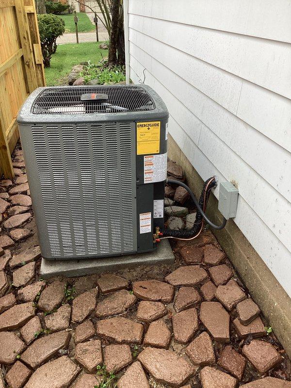 Completed full installation of new furnace and air conditioning system at residential property. Outdoor condensing unit installed on concrete pad in side yard with proper electrical conduit and refrigerant line connections through exterior wall. System installed, tested, and operational with all components functioning to manufacturer specifications.