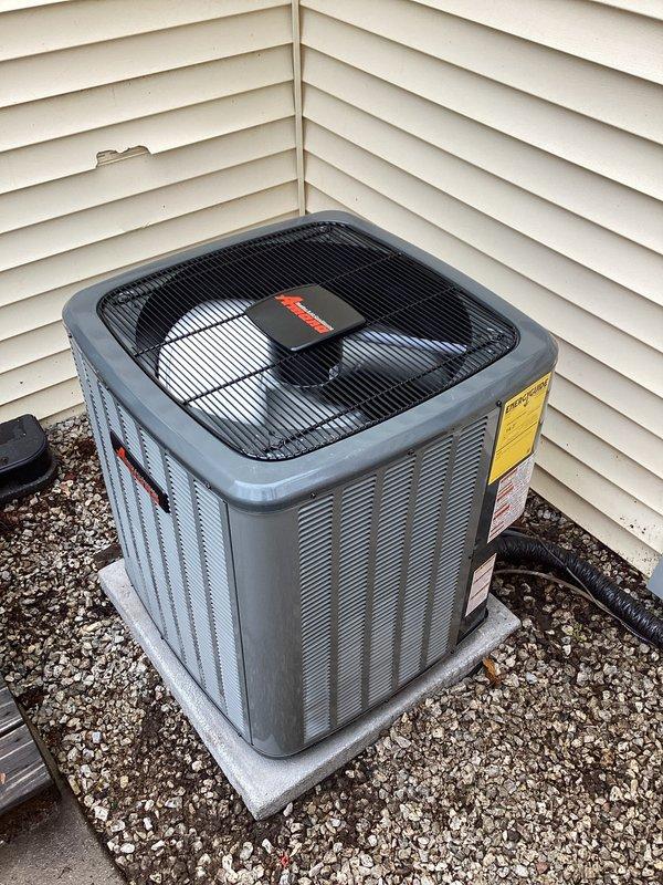 Completed full HVAC system replacement including outdoor condensing unit and indoor air handler/furnace. Installed new AC condenser on existing concrete pad with proper gravel base, ensuring level placement and adequate clearance from structure. Unit features protective top grille and proper ventilation louvers. Connected refrigerant lines using insulated line set with black corrugated protective covering. Installed matching indoor furnace unit in mechanical closet with complete PVC condensate drainage system and venting configuration. Verified all manufacturer labels and safety documentation properly affixed to equipment. Tested system operation, confirmed proper airflow, checked refrigerant charge levels, and verified all electrical connections meet code requirements. System operational and performing to manufacturer specifications.